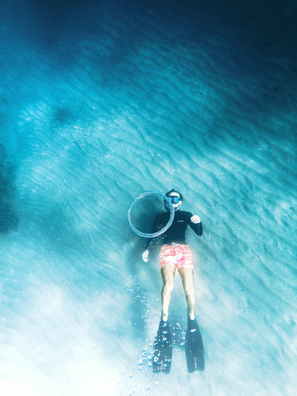 uma mulher está flutuando na água com um balde nas costas