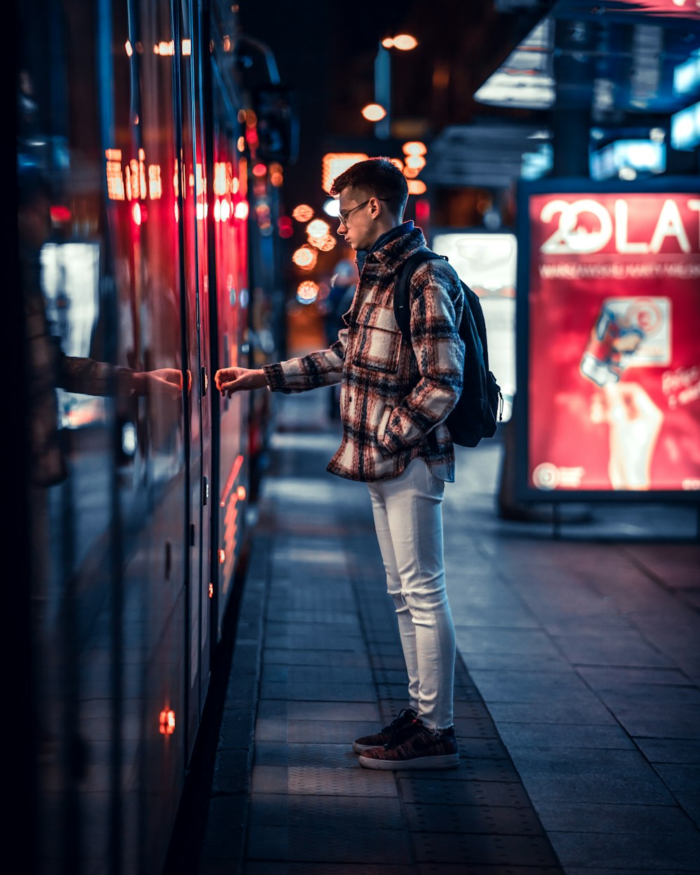 a person walking down a sidewalk in front of a store