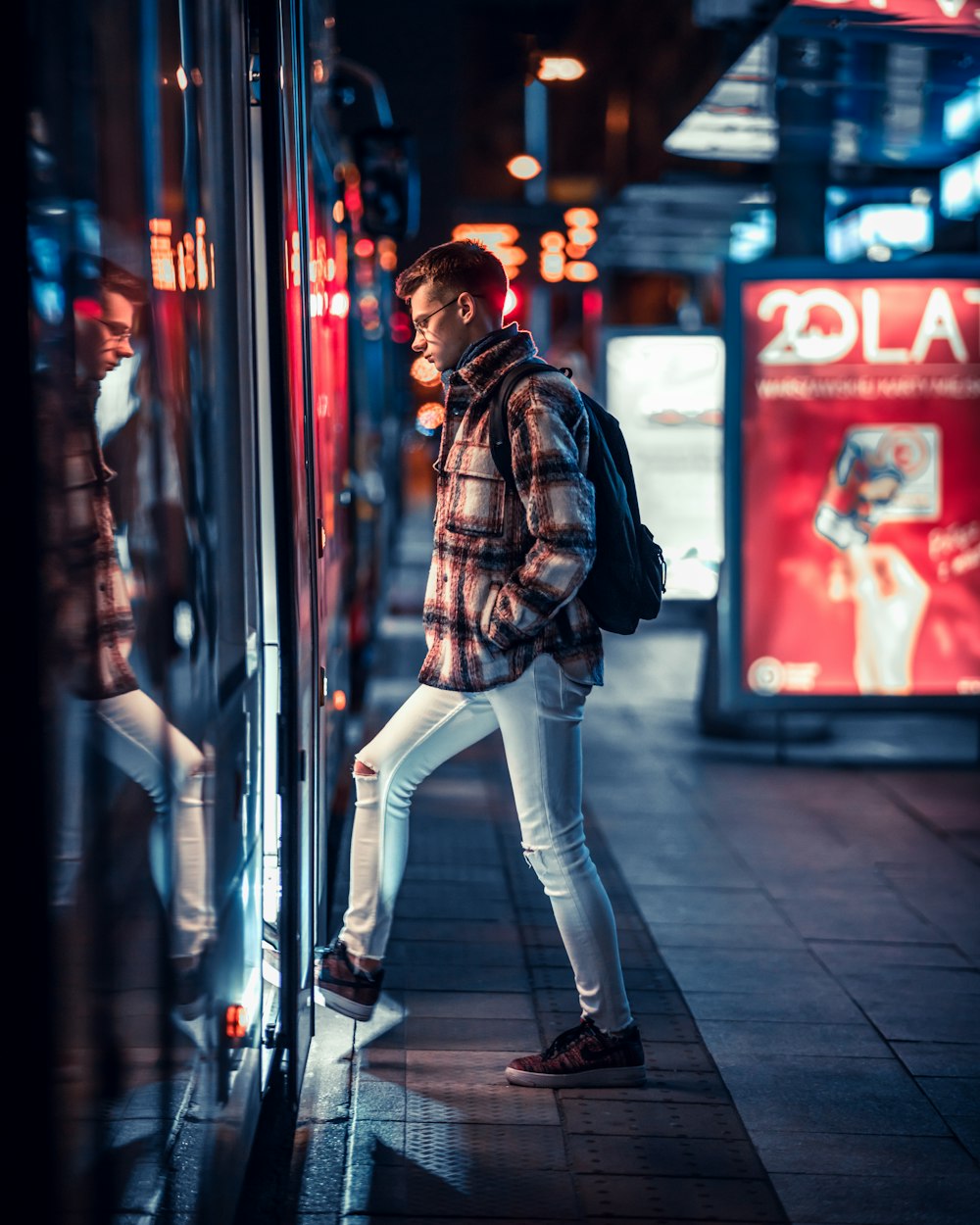 a person walking down a sidewalk in front of a store