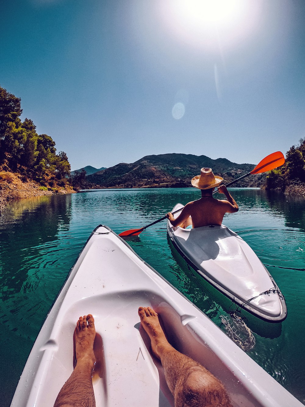 a man in a hat is paddling a boat