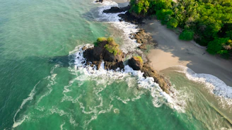an aerial view of a beach with waves crashing on it