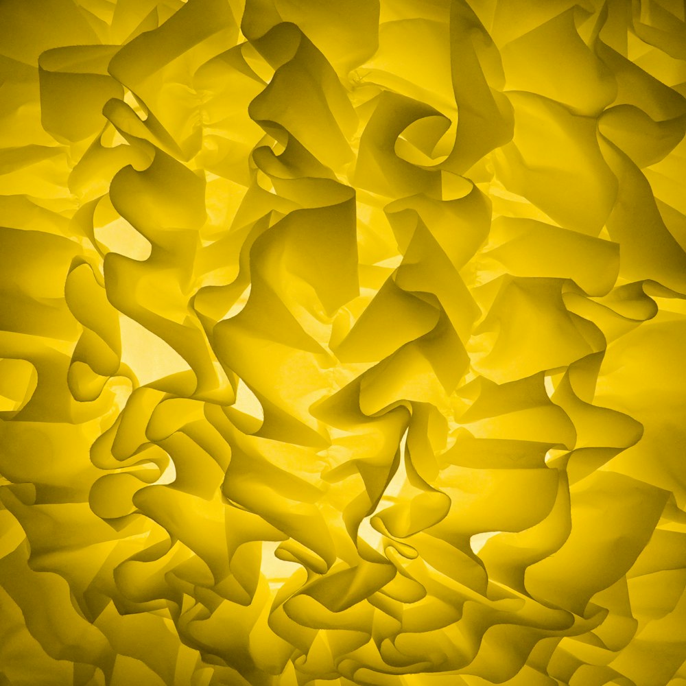 a close up of a yellow wall with a pattern