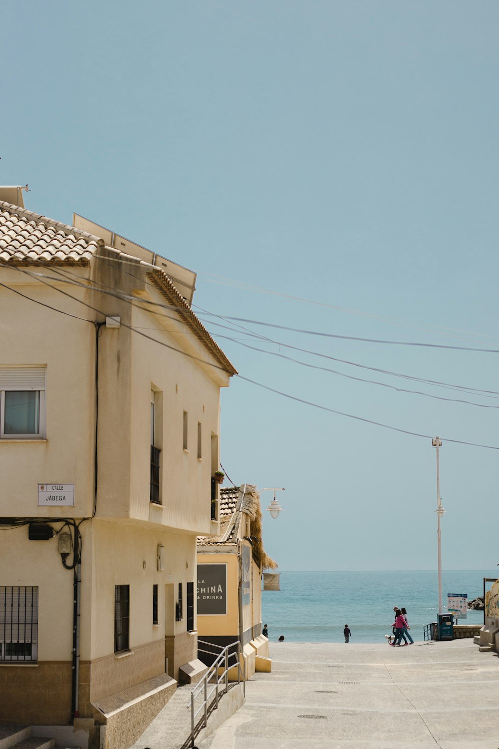 a couple of buildings sitting next to the ocean