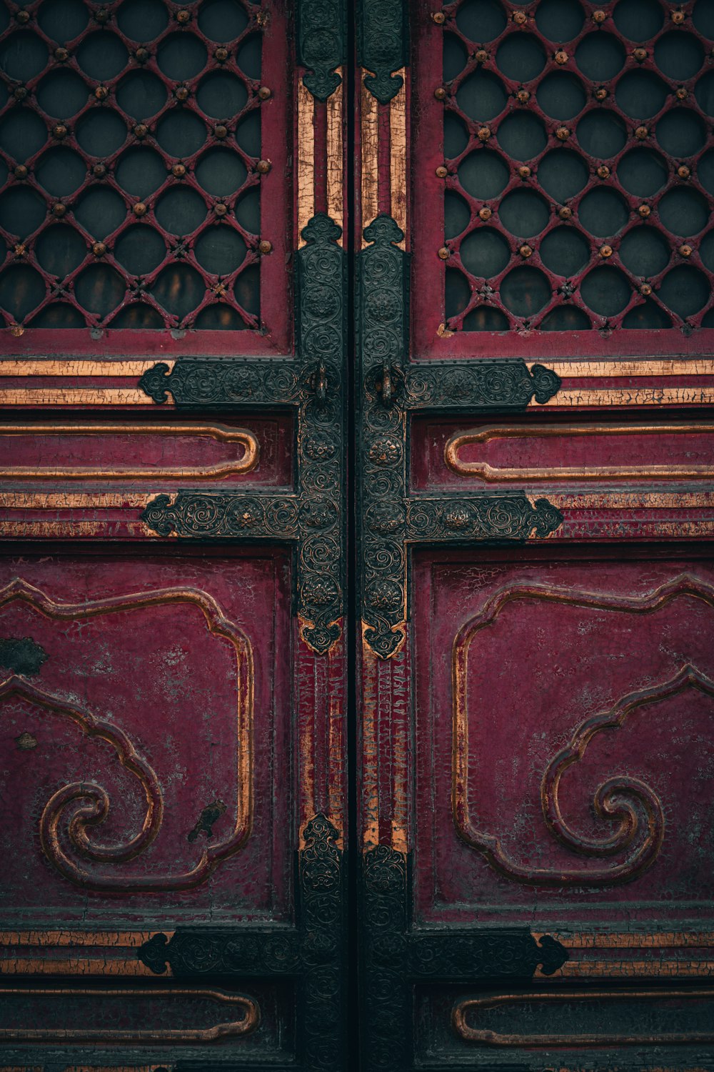 a close up of a metal door with a clock on it