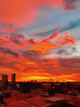 A striking large-format photograph showcasing a vibrant sunset over a cityscape.