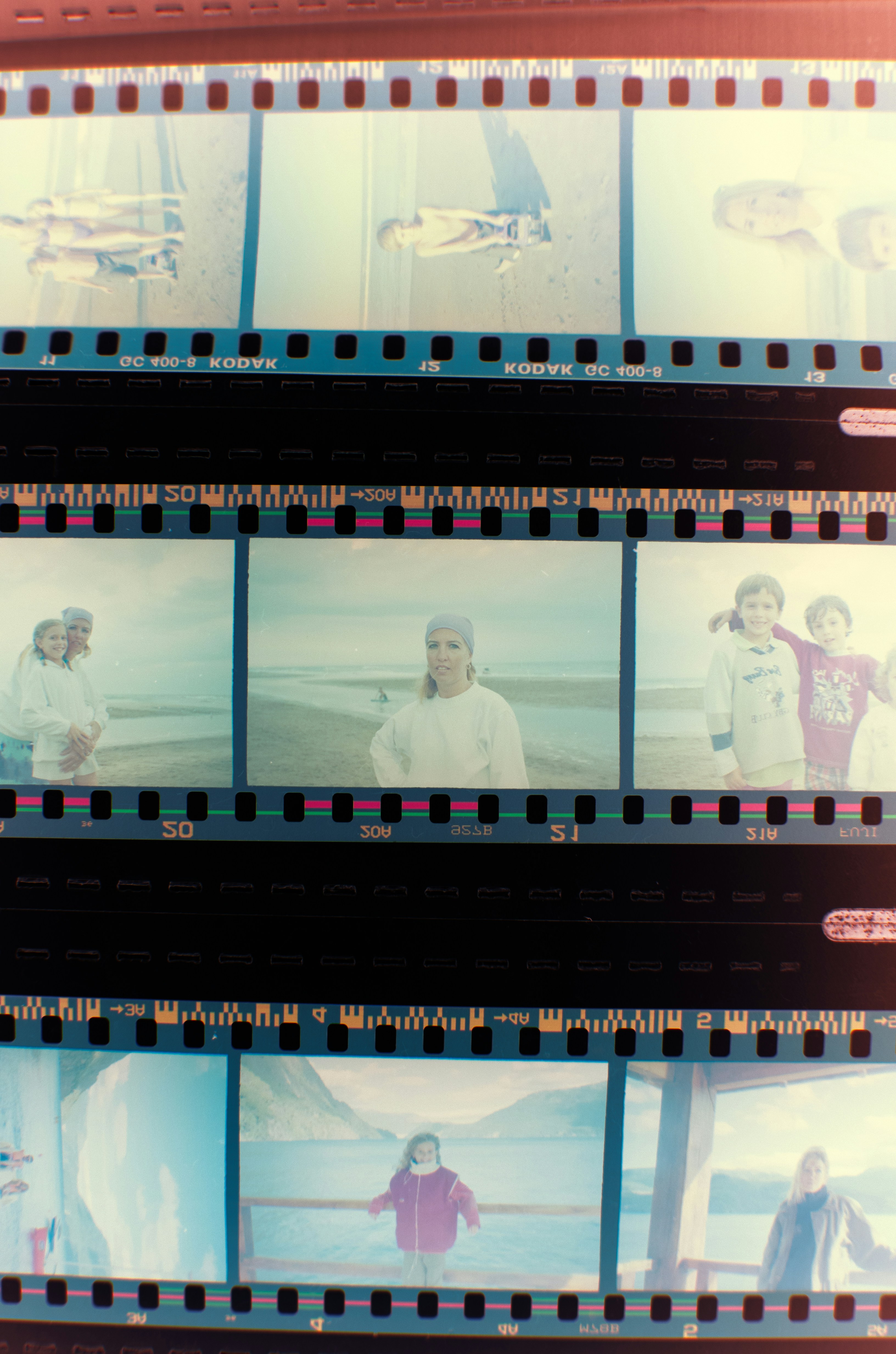 a group of people standing on a beach next to each other