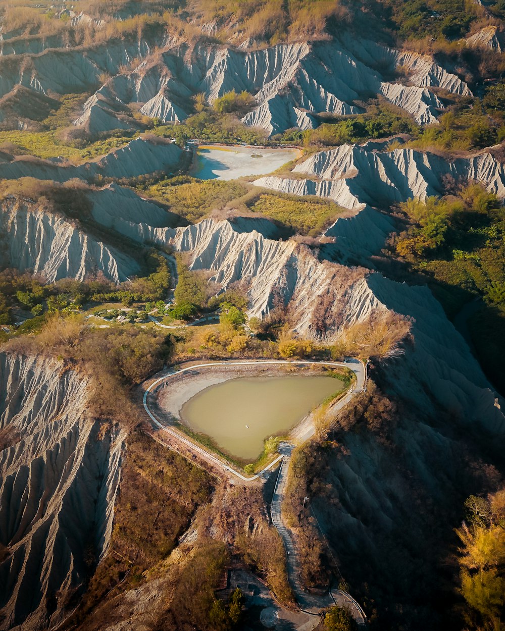 an aerial view of a mountain range with a lake in the middle