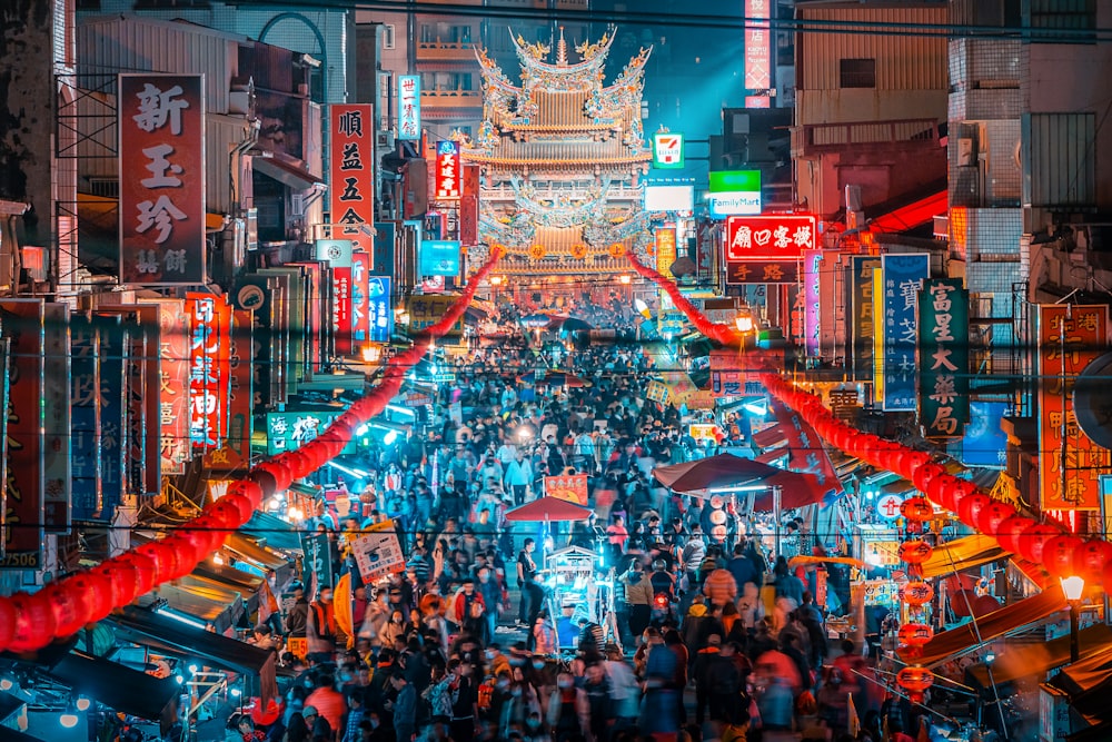 a crowded city street filled with lots of people