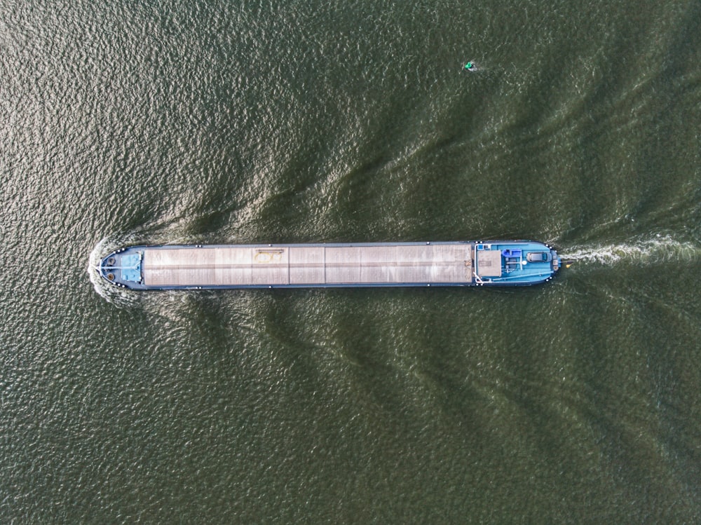an aerial view of a boat in a body of water