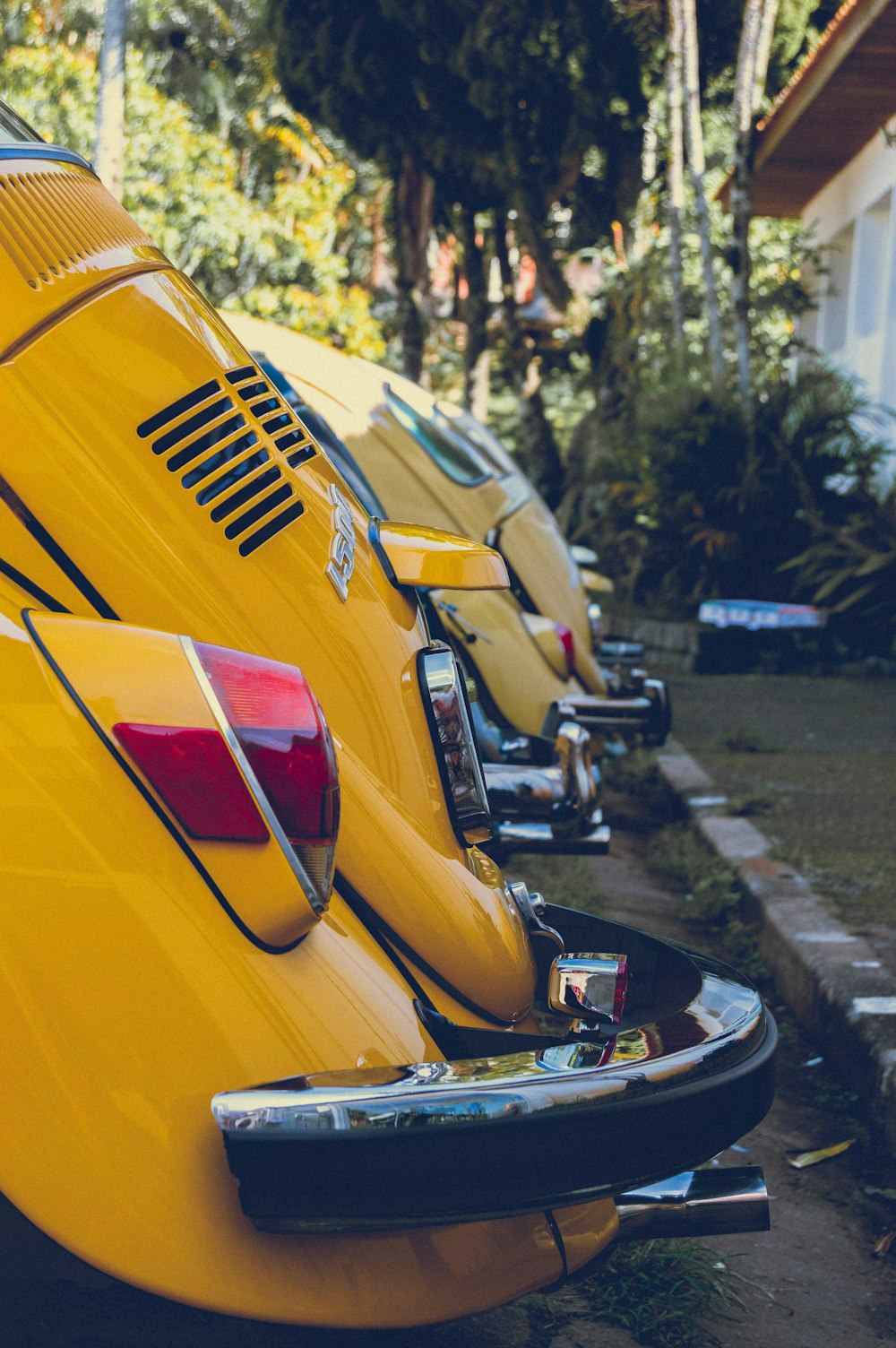 a row of yellow cars parked next to each other