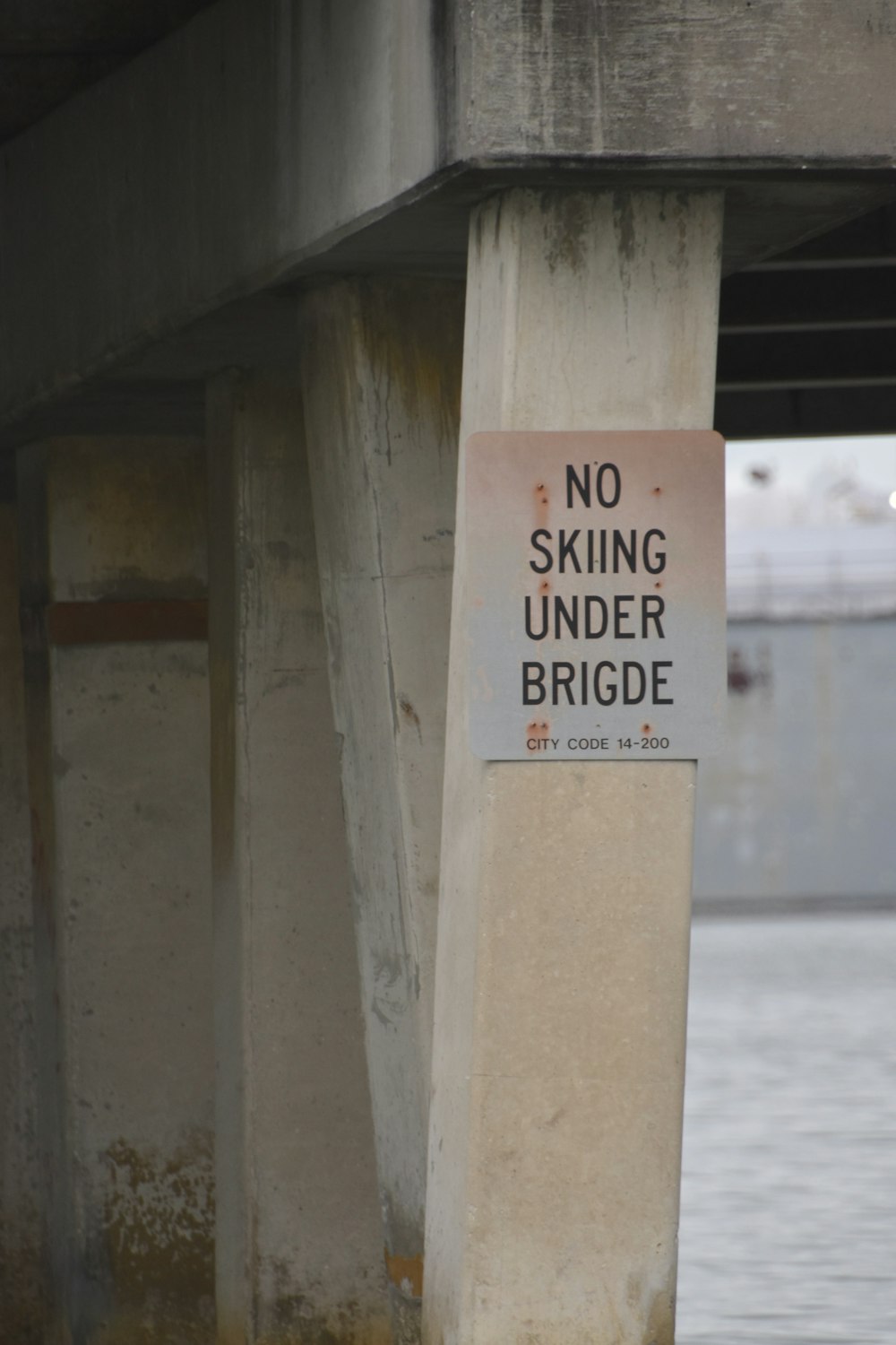 a no skiing under bridge sign under a bridge