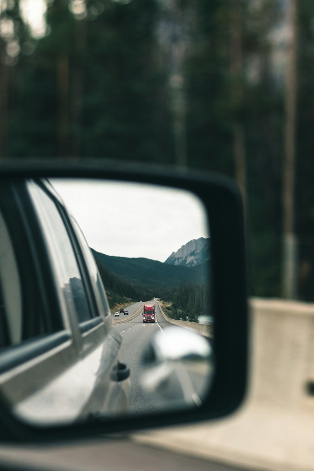 a rear view mirror on a car reflecting a truck