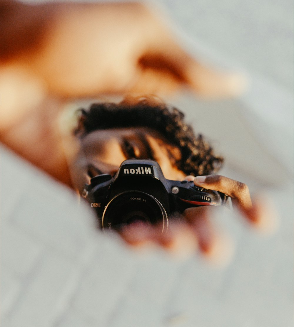 a person holding a camera in their hand