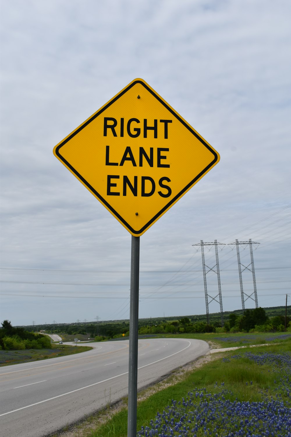 a yellow sign that says right lane ends