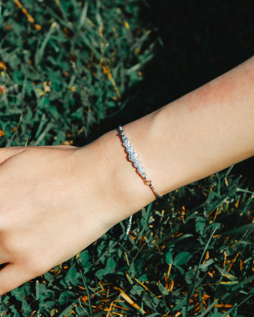 a woman's arm with a bracelet on it