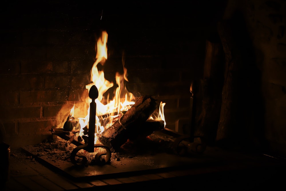 a fire burning in a fireplace in a dark room