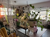 A stylish living room adorned with hanging plants and decorative pots, blending nature with modern decor.