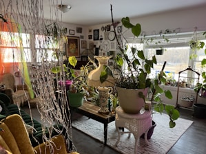 A cozy living room with modern furniture and decorative plants.