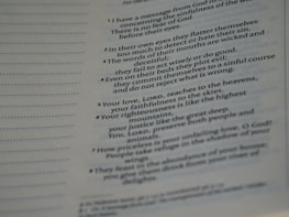 A close-up view of a page from a book presenting text in paragraph form. The text includes numbered points and is slightly blurred towards the edges, indicating shallow depth of field. The page features both bold and regular font styles indicating different emphasis on certain parts.
