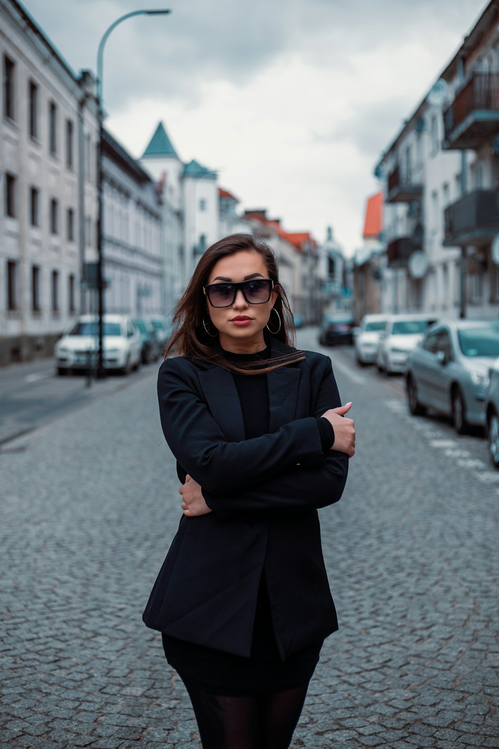 a woman standing in the middle of a street