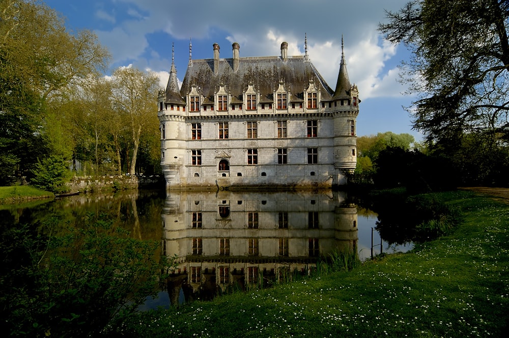 a castle with a pond in front of it