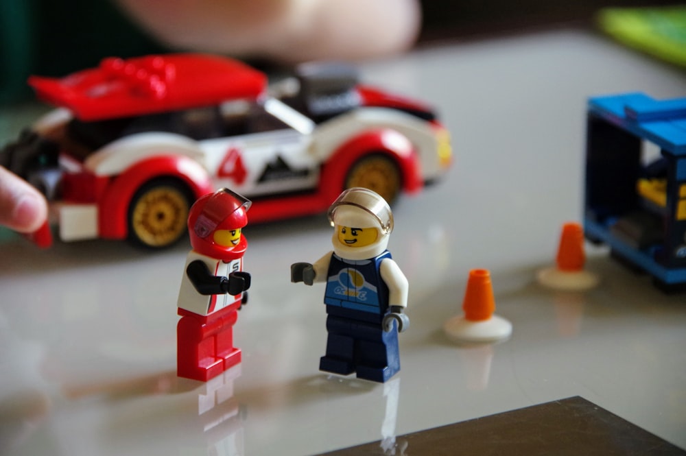 a lego man and a lego car on a table