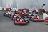Children wearing helmets excitedly waiting to start their kart race.
