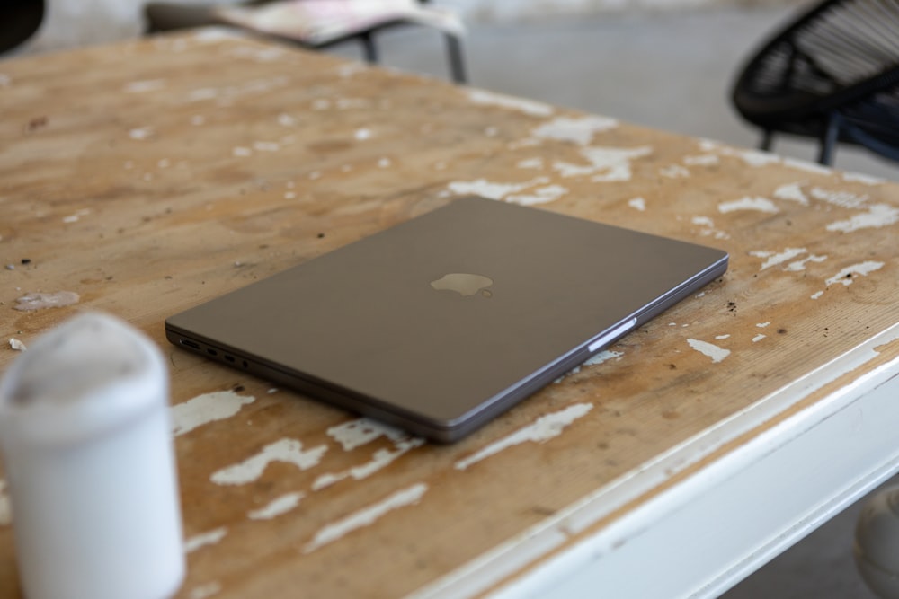 a laptop computer sitting on top of a wooden table