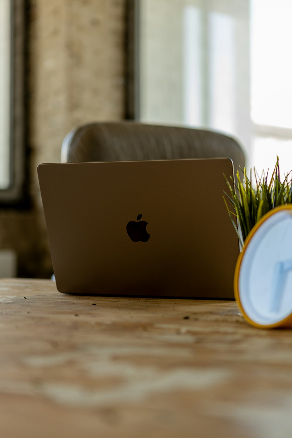 a laptop computer sitting on top of a wooden table