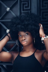 a woman with an afro is posing for a picture