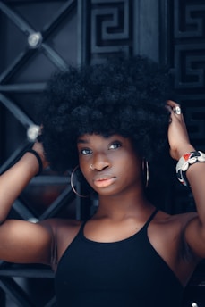a woman with an afro is posing for a picture