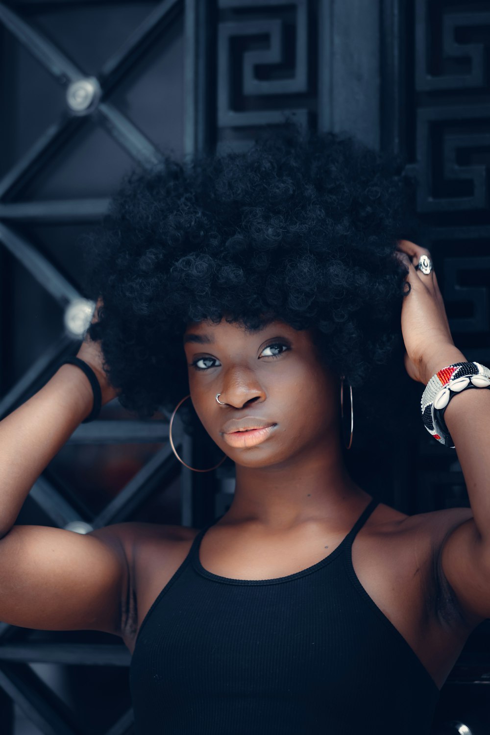 a woman with an afro is posing for a picture