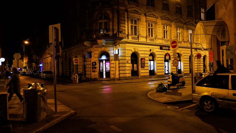 a car parked on the side of a street at night