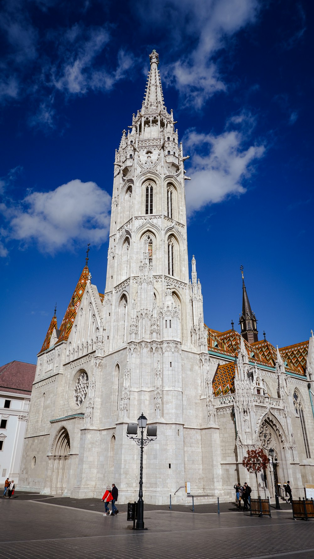 a tall white building with a clock on it's side