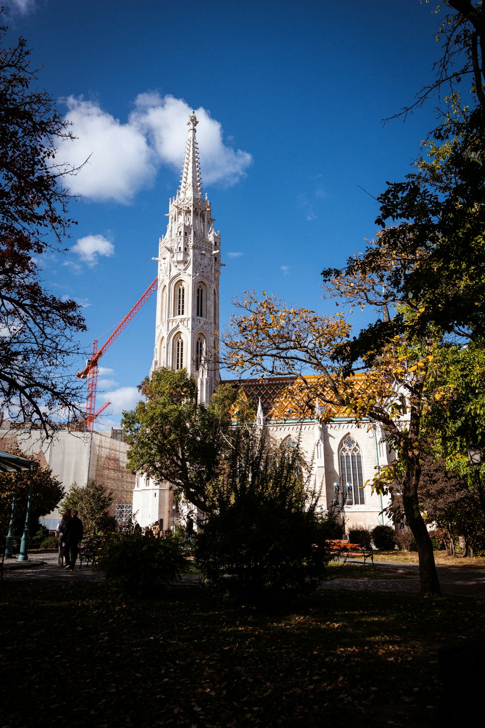 a church with a tall steeple surrounded by trees