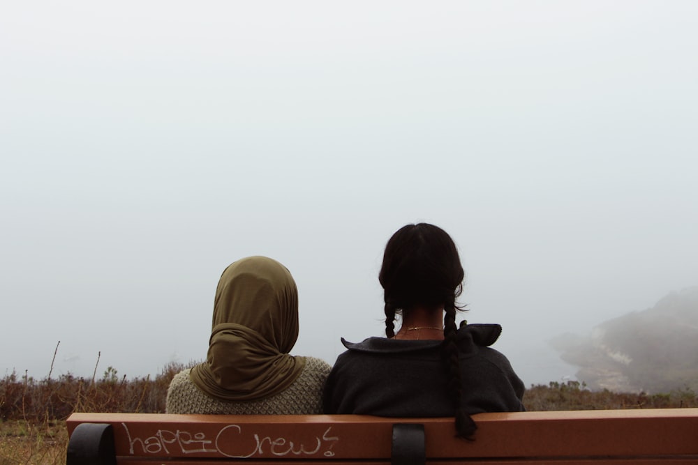 a couple of people sitting on a bench