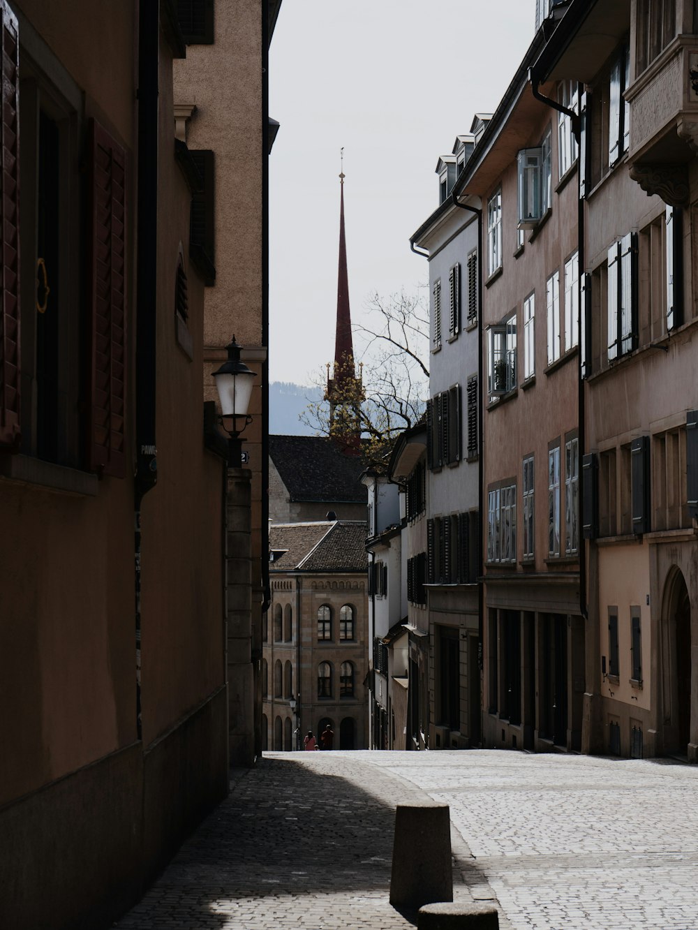 a city street with buildings and a clock tower in the distance