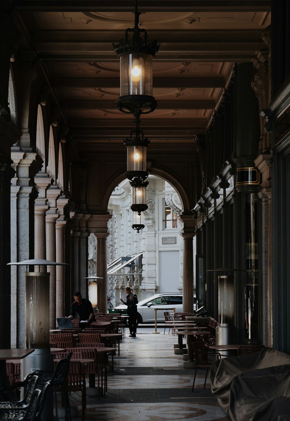 a couple of people sitting at a table under a light