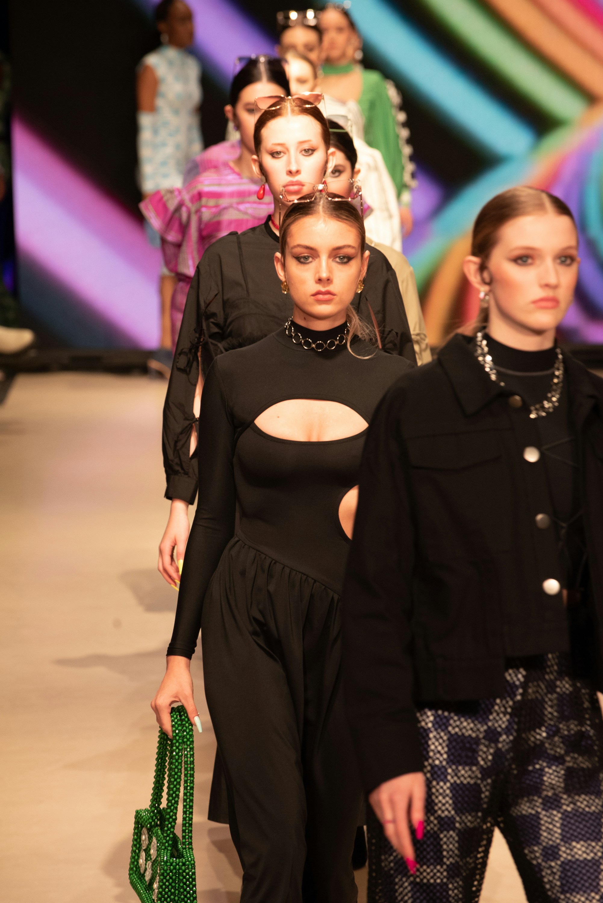 a group of women walking down a runway