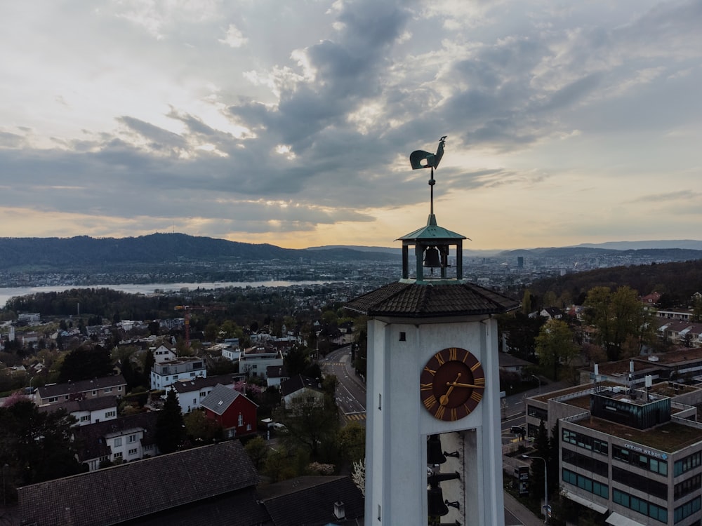 a clock tower with a weather vane on top of it