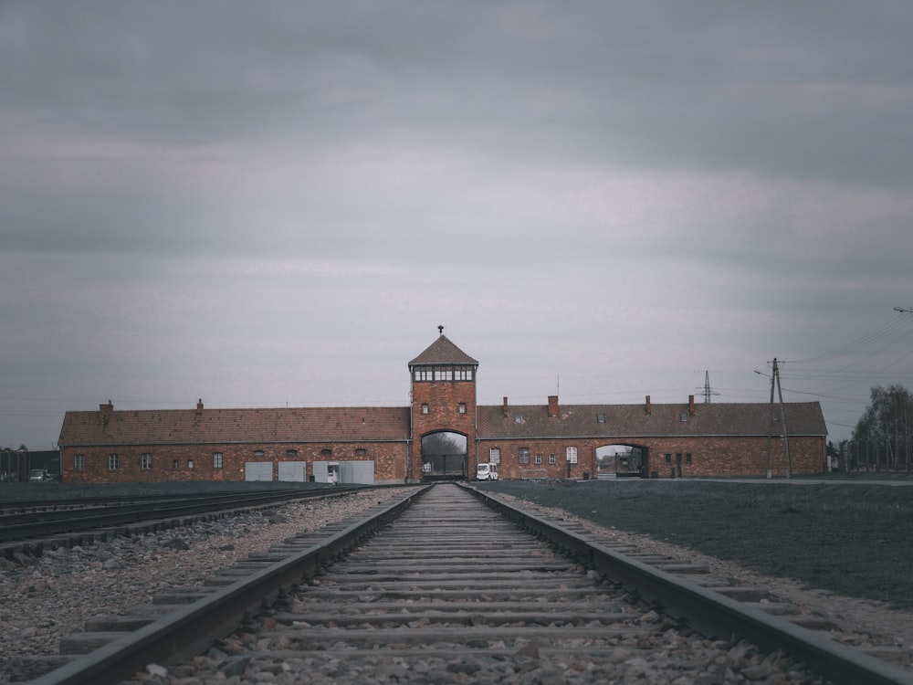 a train track with a building in the background