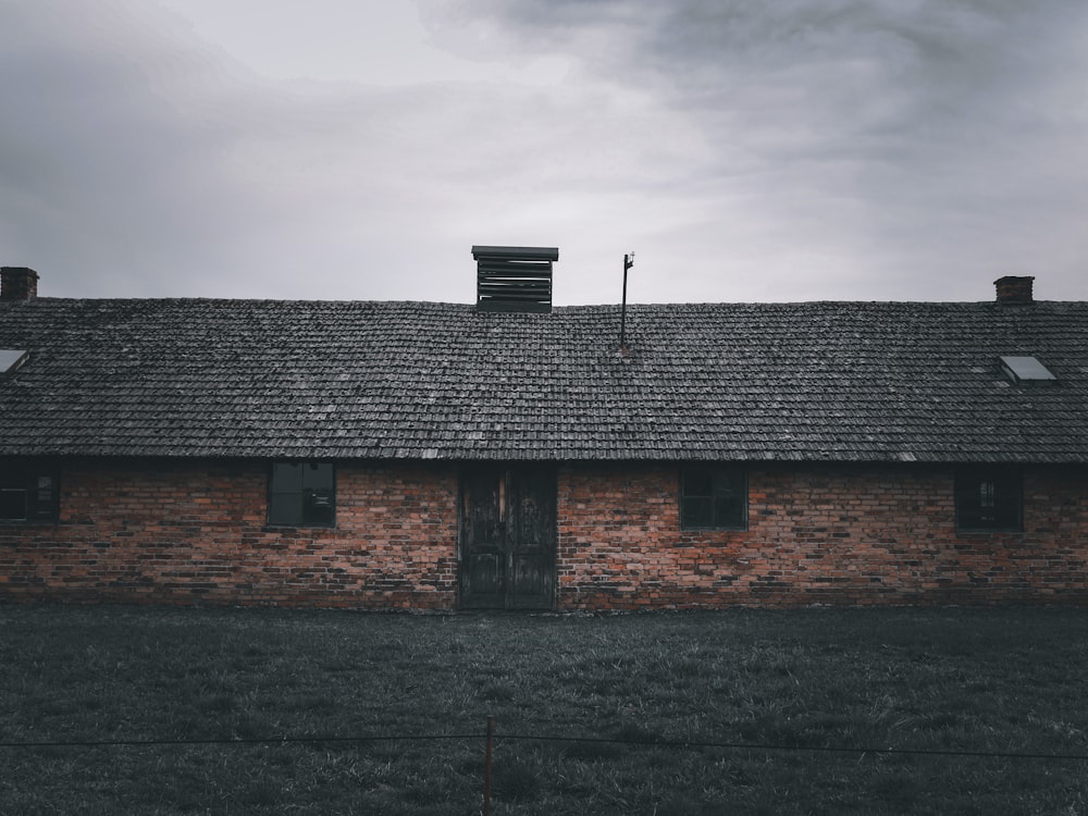 an old brick building with a weather vane on top of it