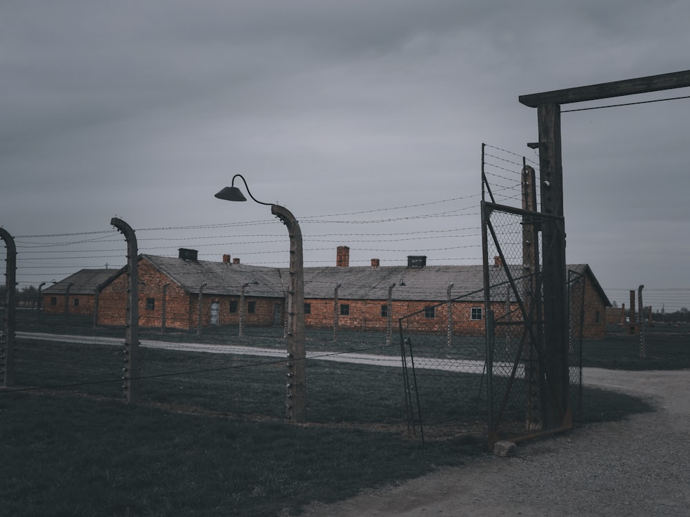 a building behind a barbed wire fence