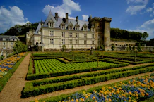 a large building with a garden in front of it