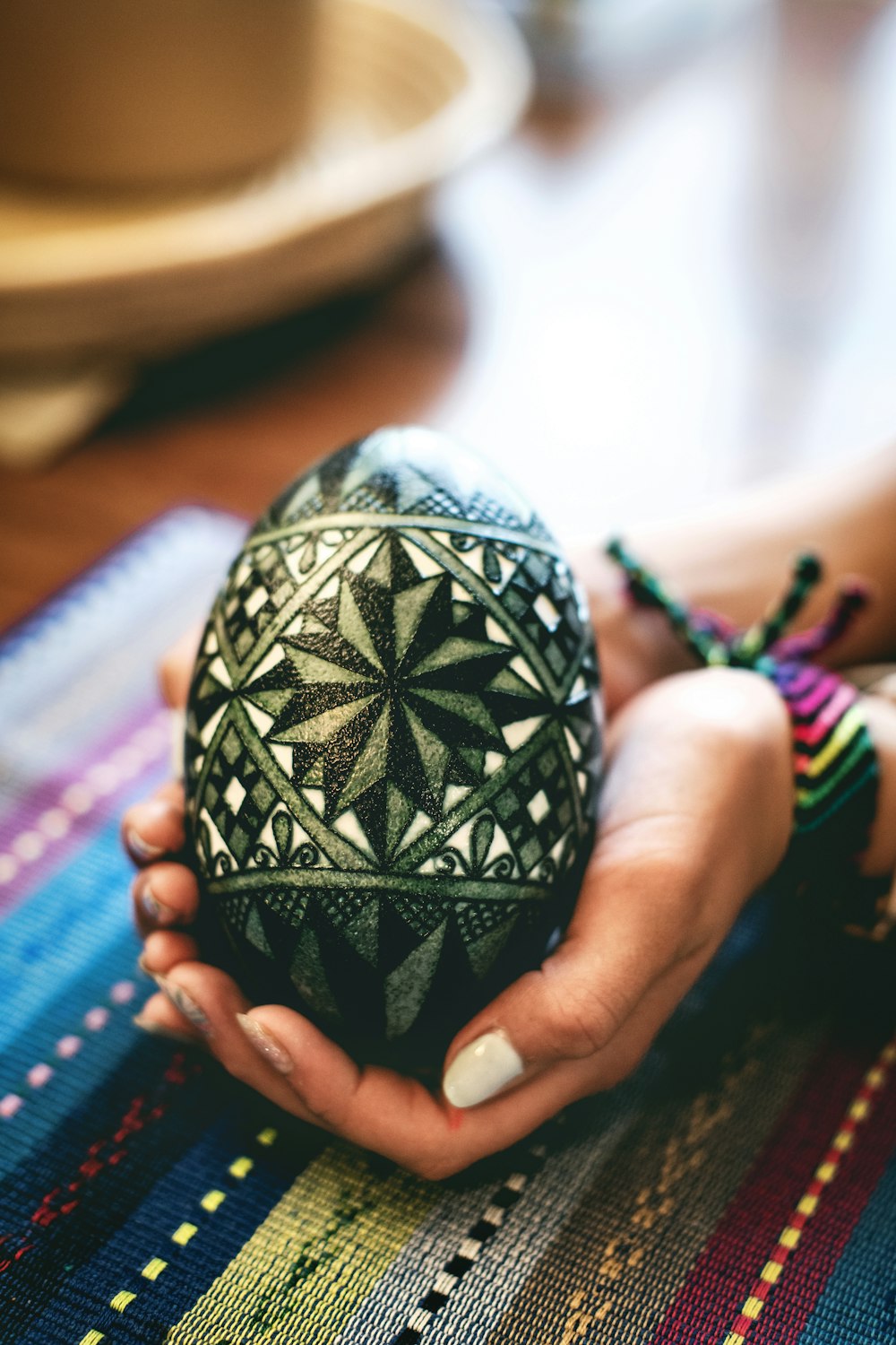 a person holding a decorative object in their hands