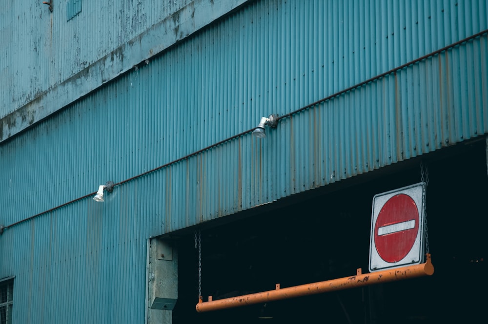 a red and white sign hanging from the side of a building