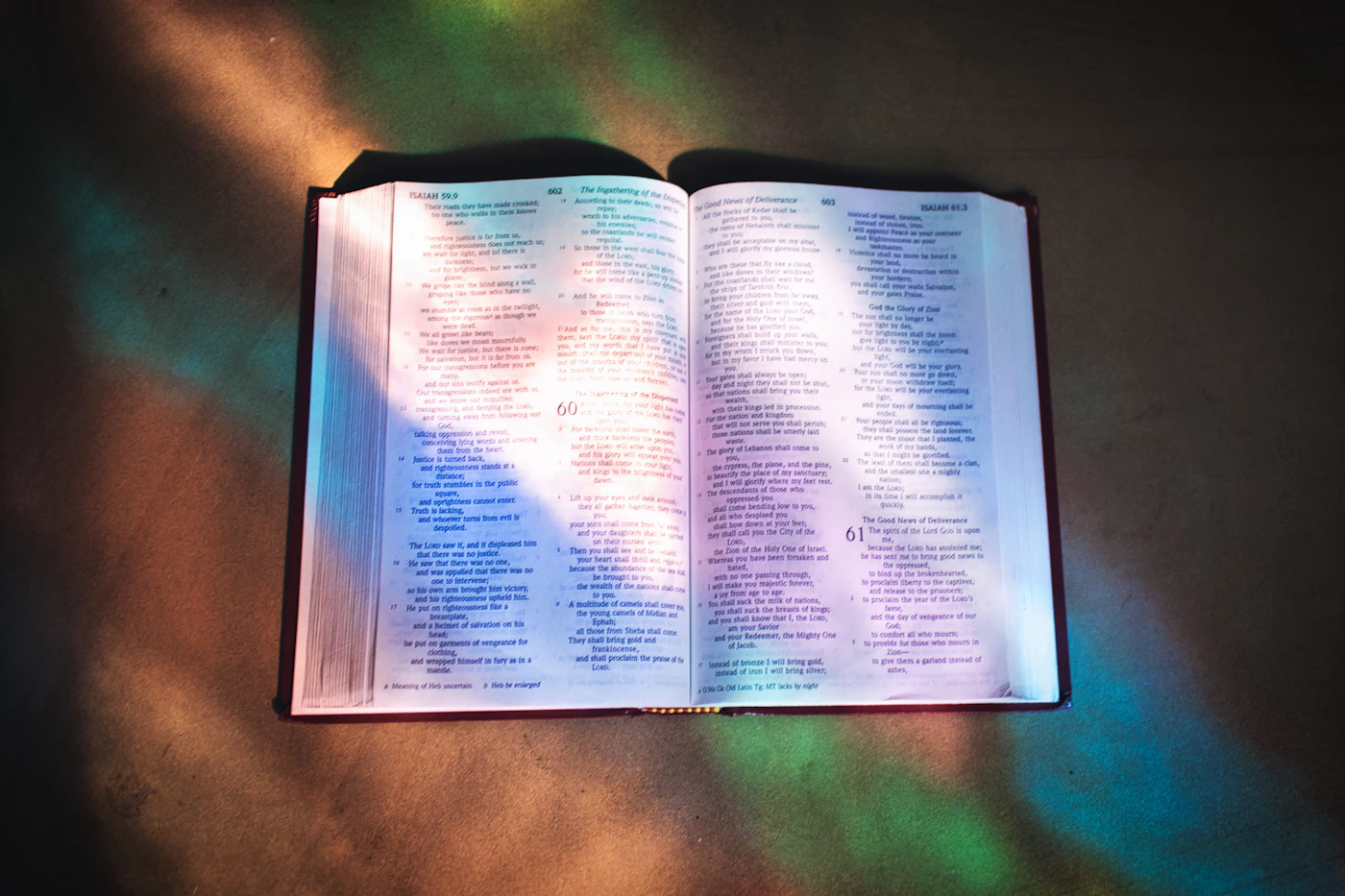 Journal, laptop, and faith-centered care materials in soft morning light
