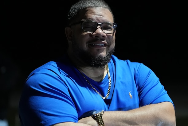a man in a blue shirt with his arms crossed
