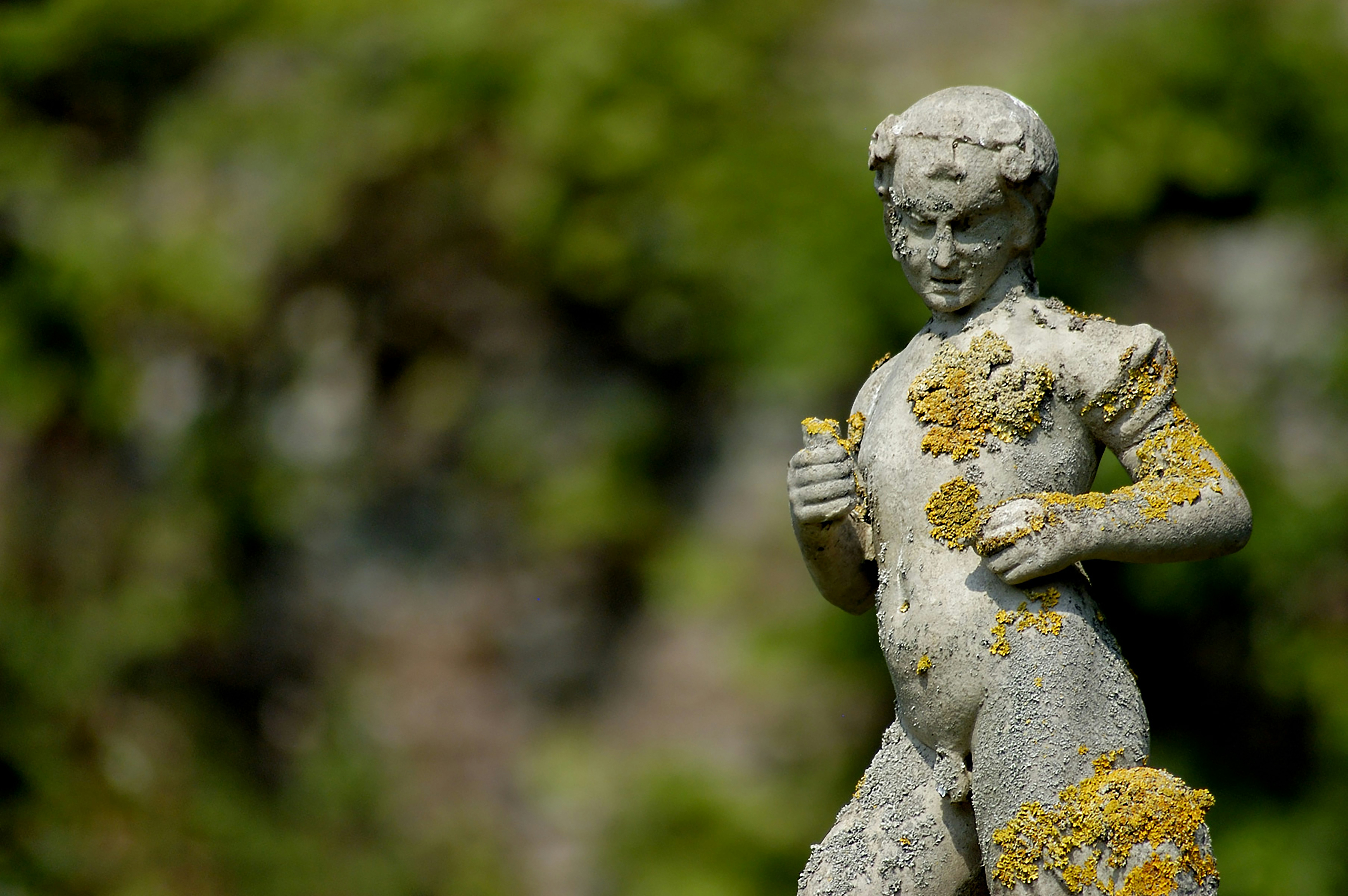 a statue of a boy holding a teddy bear