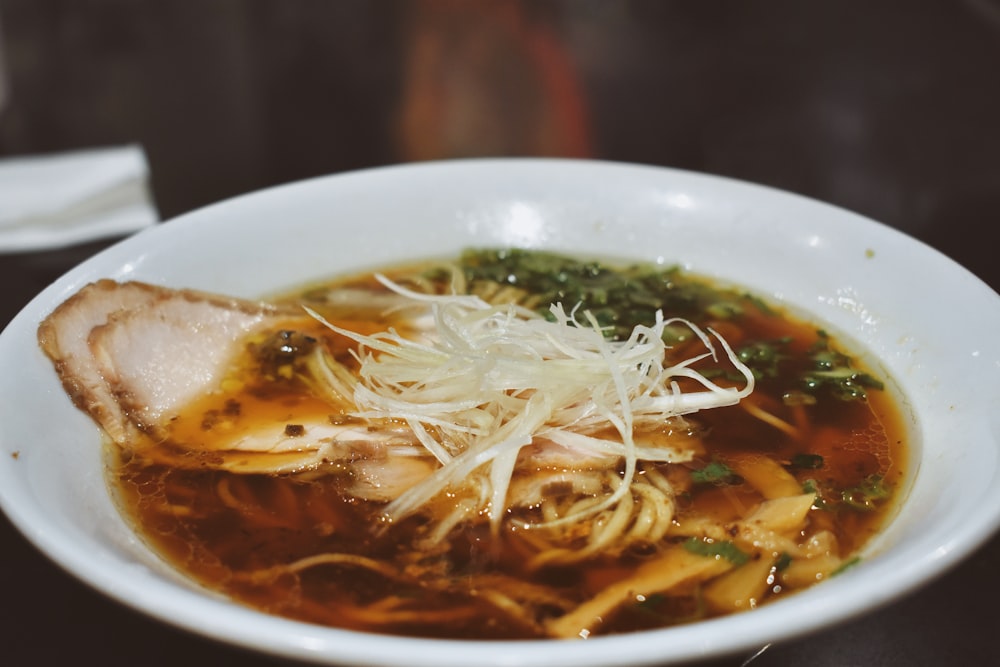 a bowl of soup with meat and noodles